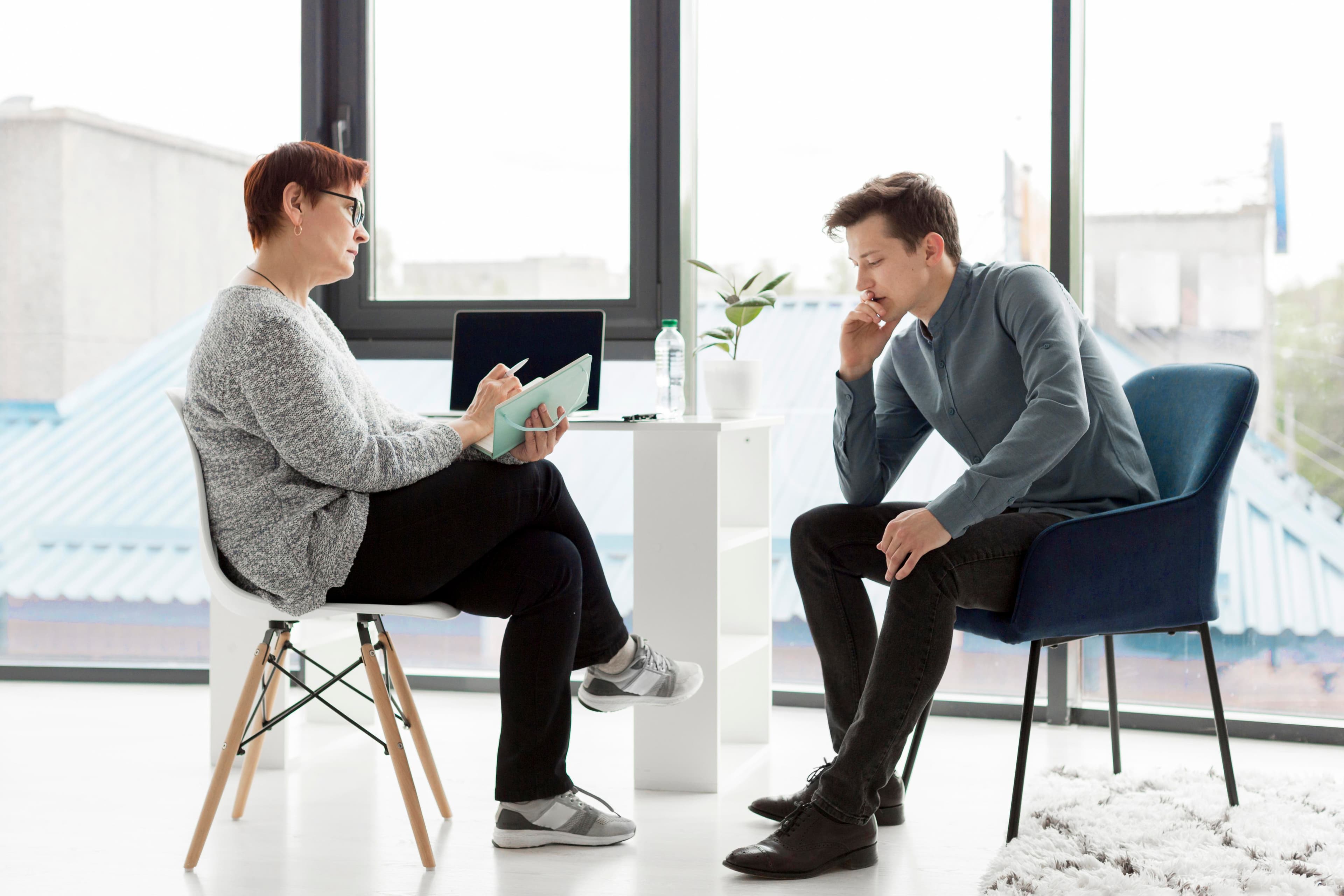 man and a woman sitting on chair